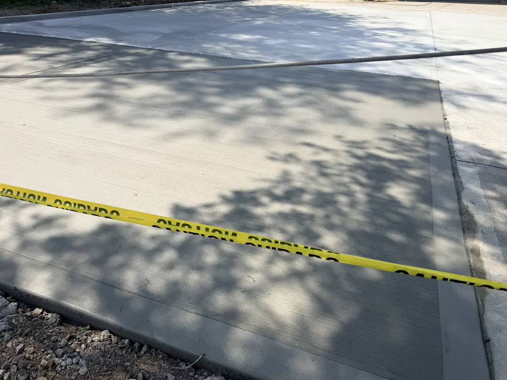 Fresh concrete driveway taped off to cure in Knoxville, Tennessee