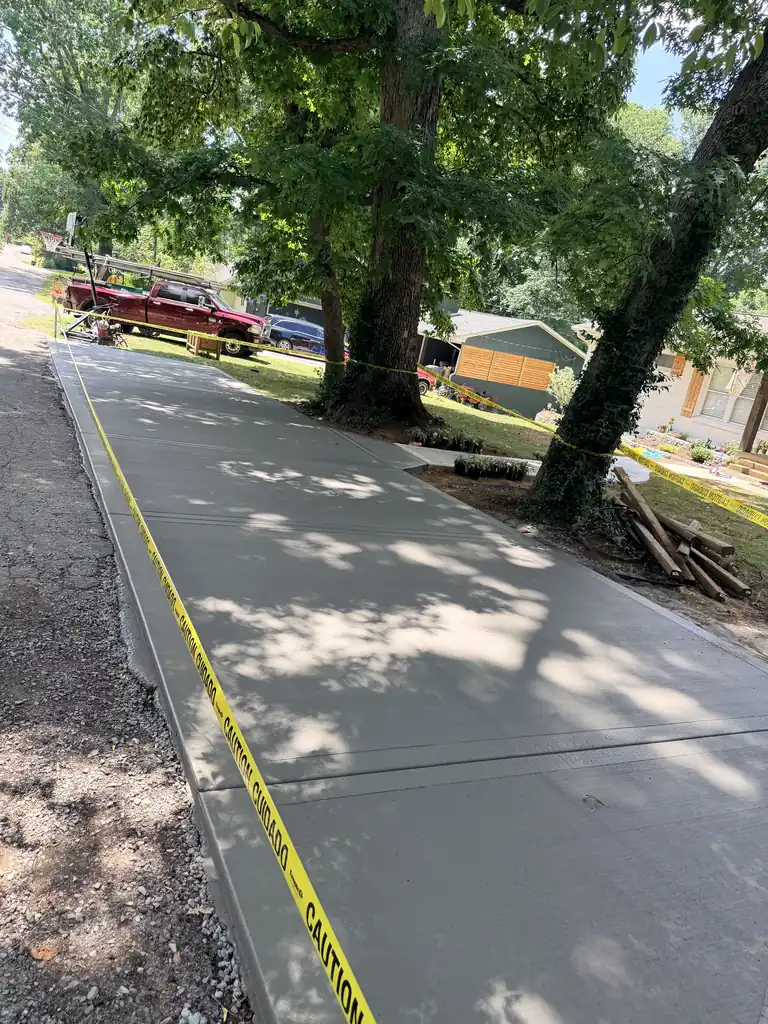 Freshly poured concrete driveway under shade trees in Knoxville, Tennessee