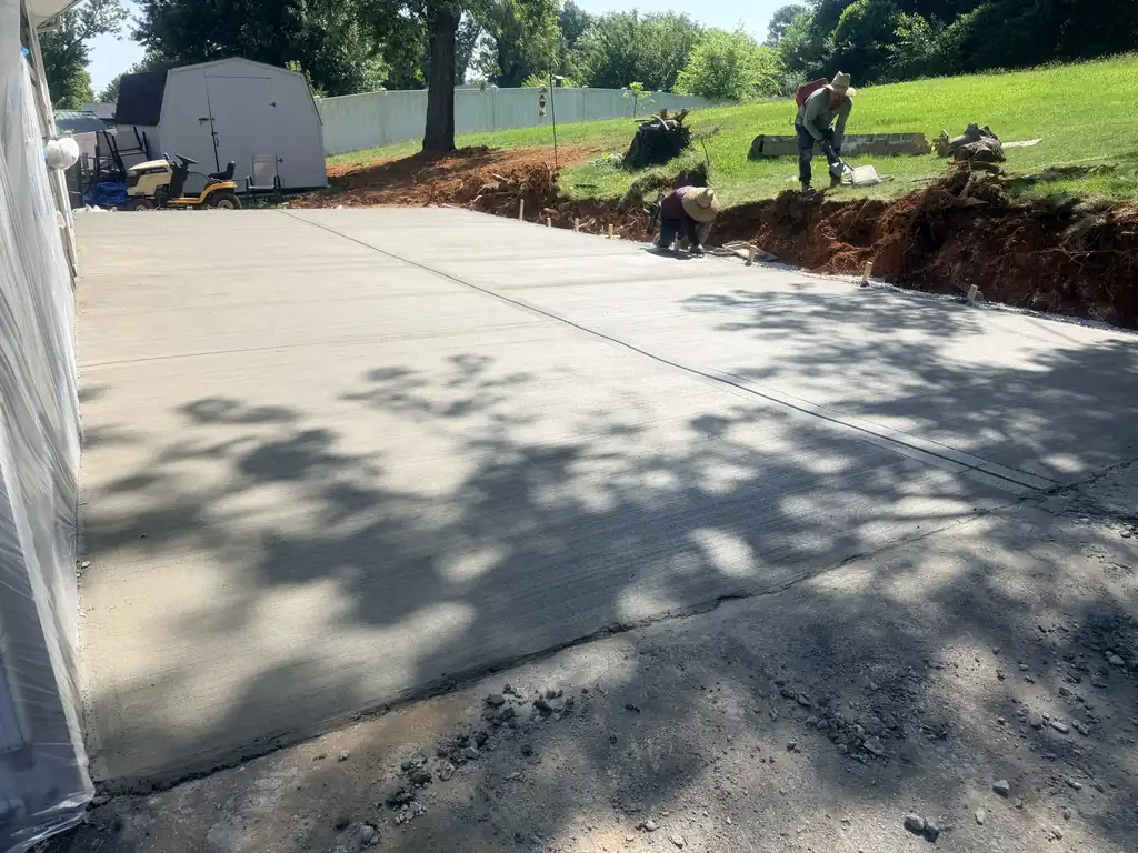 New concrete parking pad poured beside a house in Knoxville, Tennessee