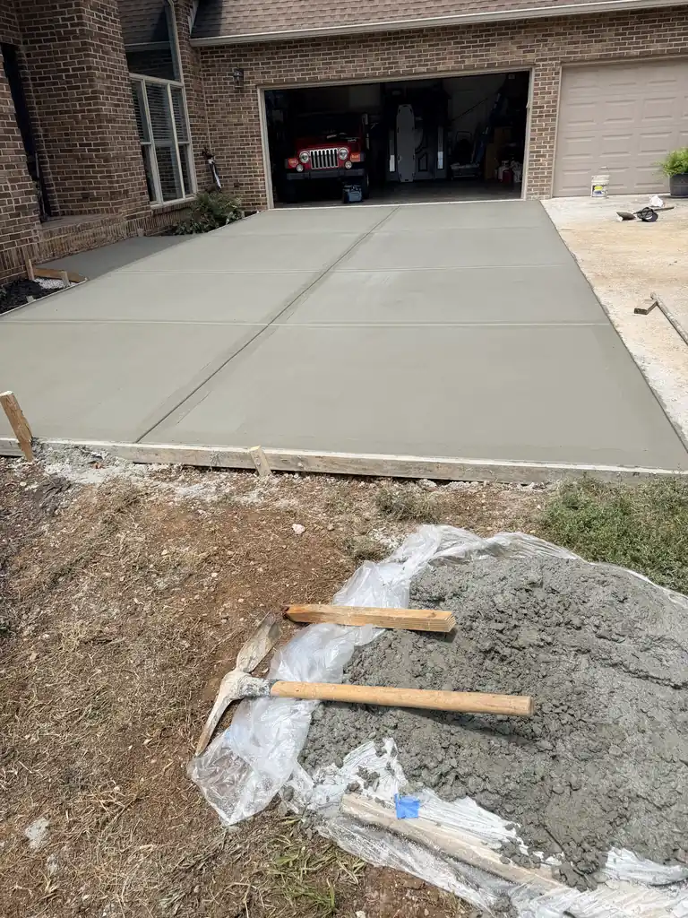 New concrete driveway poured up to the garage doors in Knoxville, Tennessee