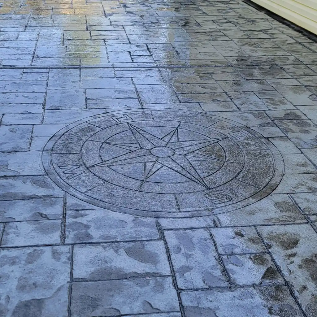Custom compass rose medallion set into stamped concrete by Sosa Concrete in Knoxville, Tennessee
